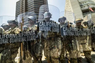 California National Guard soldiers stand with shields outside the Federal Detention Center in downtown Los Angeles, on June 8, 2025. Photo by Ted Soqui for CalMatters